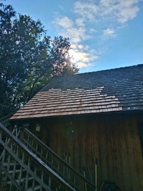 New cedar shingles patched into a weathered shake roof